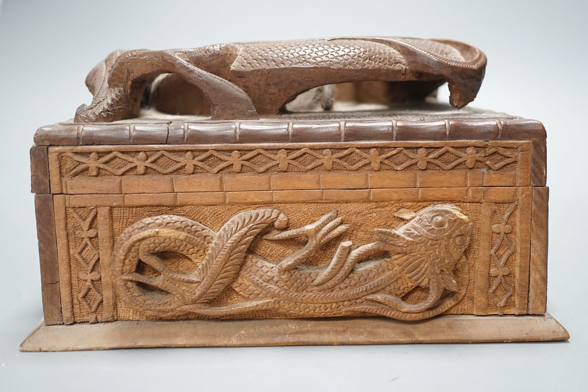 A Burmese carved wood 'Dragon' box, 31cm wide